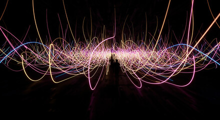 Immersive neon light trails background with human silhouettes in dark space
