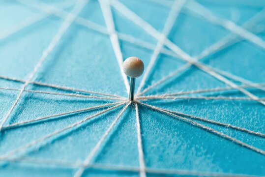 Pin connected by threads with a blue background