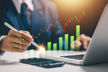 A professional analyzes a rising financial chart using a stylus and laptop, representing investment growth, market strategy, financial planning, profit forecasting, and wealth management.