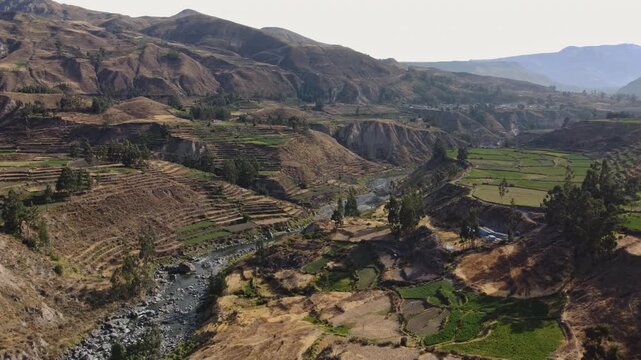 Wide angle aerial drone flying forward over Colca Valley and Colca River, Peru
