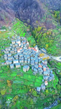 Piodao historic schist village on slope of Serra do Acor mountains in central Portugal. Aerial view. Orbiting. Vertical Video