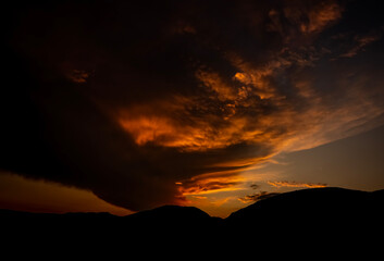 Dramatic sunset background with cloudy sky.