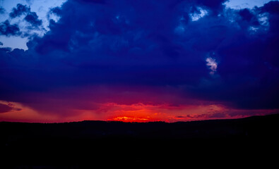 Dramatic sunset background with cloudy sky.