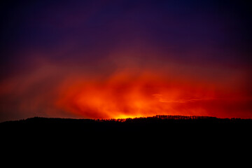 Dramatic sunset background with cloudy sky.