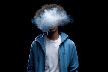 Young african male vaping with smoke in blue hoodie