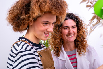 Two women collaborating and smiling in a professional setting