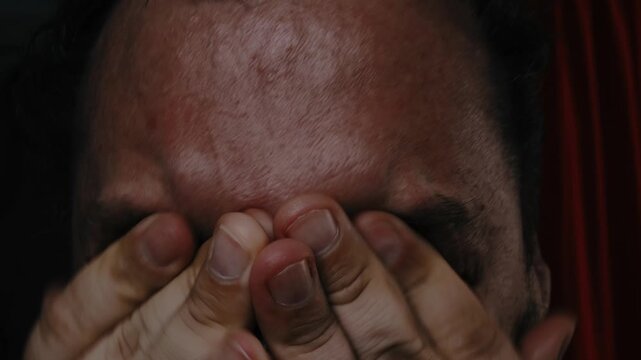 A grown man screams and cries in despair.