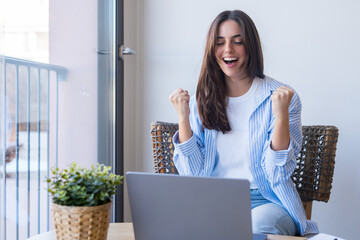 Funny euphoric young caucasian woman celebrating winning or getting ecommerce shopping offer on...