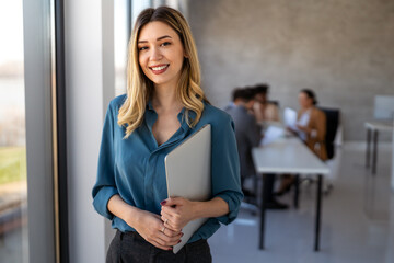 Professional in office environment, highlighting teamwork, collaboration, leadership, and innovation