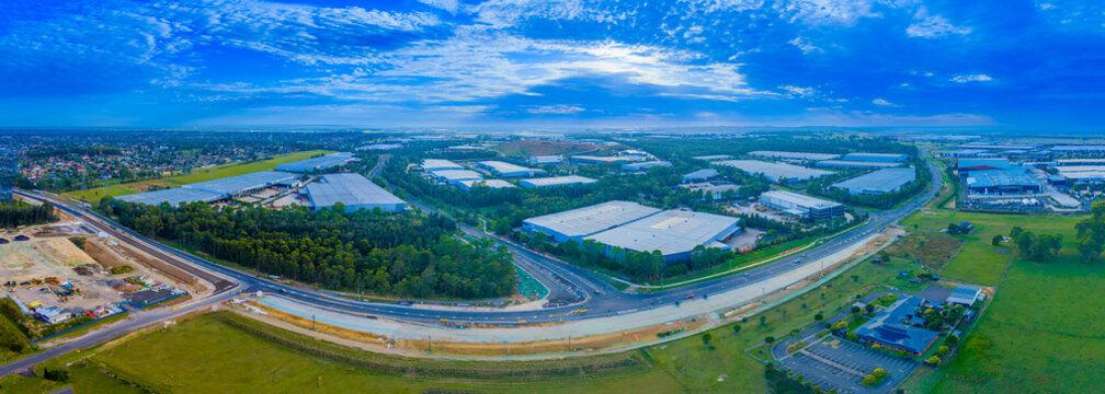Drone aerial panoramic photograph of some of the buildings in the large industrial precinct of Kemps Creek in western Sydney in New South Wales, Australia.
