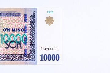 A 2017 banknote of 10000 Uzbek soums. The obverse depicts the state emblem. The reverse side of the banknote features an image of the Senate building in Tashkent.