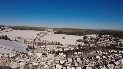 Obraz premium Aerial winter forest in the Black Forest with snow and rural landscape