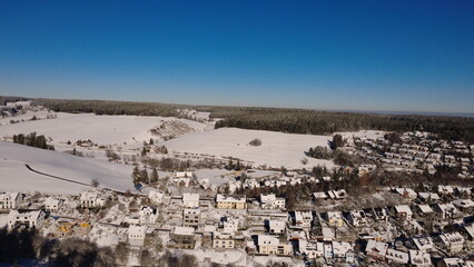 Obraz premium Aerial winter forest in the Black Forest with snow and rural landscape