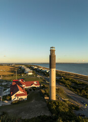 Aerial view of the Oak Island Lighthouse in Caswell Beach North Carolina at sunset
