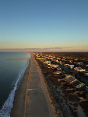 Aerial view of the pier and beach at sunrise in Oak Island , Brunswick County, North Carolina