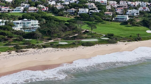 Luxury Living in the Golden Triangle: Cinematic 4K Aerial of Vale do Lobo Royal Golf Course and the Iconic Crimson Cliffs of Praia do Trafal, Algarve, Portugal