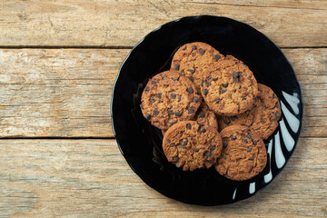 Freshly Baked Cookies on a Black Plate Placed on a Wooden Table