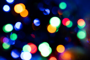 Fototapeta premium Defocused light effect bubbles light effect with multiple different colors in dark dramatic scene