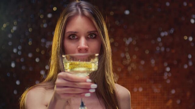 Portrait: cute woman with glass of champagne wine. Face of girl raises her Le coupe with brut. Congratulations on holiday, celebrates luxury event, Christmas atmosphere. Happy female raises a toast.