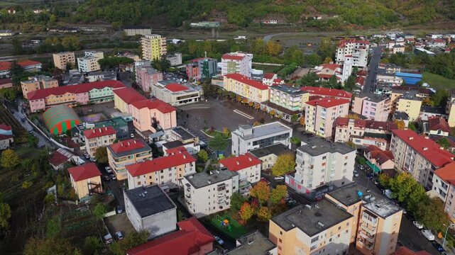 Aerial video of Rr&euml;shen with Abat Do&ccedil;i Square, colourful buildings and autumn hills stretching across the Mirdit&euml; region of Northern Albania. 