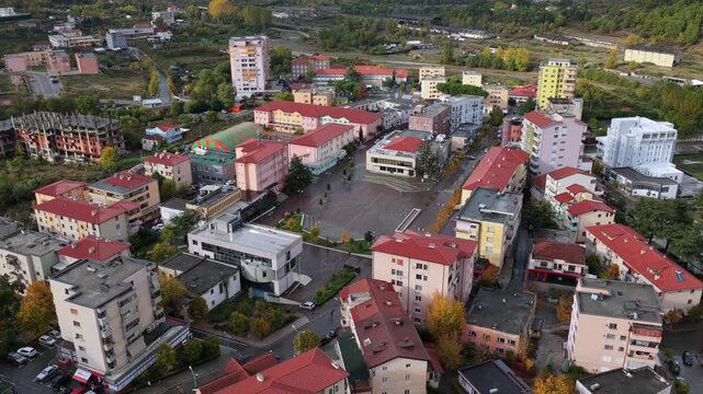 Aerial video of Rr&euml;shen with Abat Do&ccedil;i Square, colourful buildings and autumn hills stretching across the Mirdit&euml; region of Northern Albania. 