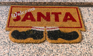 Festive touch to Christmas holiday decorations with charming Welcome Santa doormat