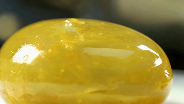 macro closeup of abstract bright yellow glossy object with ambiguous form providing artistic stock footage suitable for creative projects in cinematic