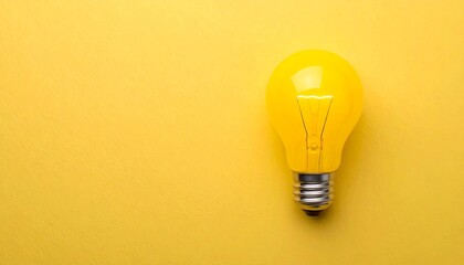 Single yellow lightbulb on yellow background