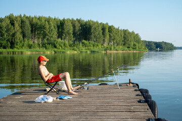 Young Boy Relaxing While Fishing on a Tranquil Lake