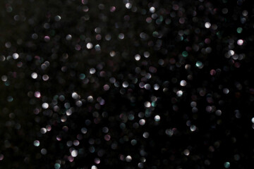 Dreamy bokeh glitter overlay with many small soft pink, teal and silver lights gently fading into...