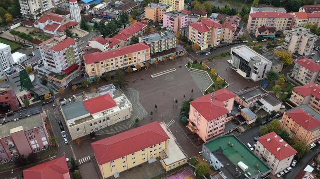 Aerial video of Rr&euml;shen with Abat Do&ccedil;i Square, colourful buildings and autumn hills stretching across the Mirdit&euml; region of Northern Albania. 