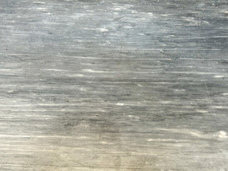 Grey scratched concrete surface creating abstract texture background © Enigma