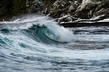 Naklejka premium Powerful Ocean Wave Curling Near Rocky Shoreline - Vancouver Island, British Columbia, Canada