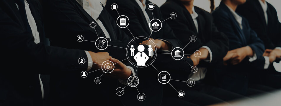 A business team engaged in collaboration with digital icons representing technology and analytics, highlighting modern workplace dynamics and strategies for success. Trope - Powered by Adobe