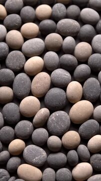 Ultra detailed macro video of small stones slowly arranged in repeating pattern