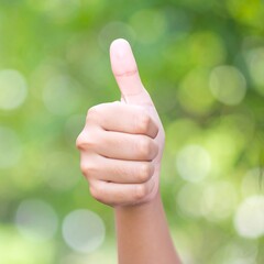 Thumbs up against bokeh