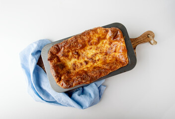 Cottage cheese casserole in a cast iron skillet, top view, space for text.
