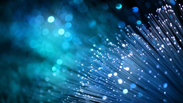 This showcases a vibrant blue and black background illuminated by numerous lights Fiber optic cables transmitting light and data