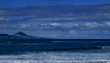Gran Canaria, December, view towards snowy Teide on Tenerife from El Confital beach on the edge of Las Palmas de Gran Canaria