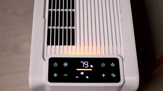 Random camera movement from the top of a dehumidifier device while working. Humidity index and the mode of work on the led display.