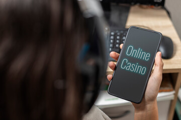 A teen holding a mobile with "online casino" text