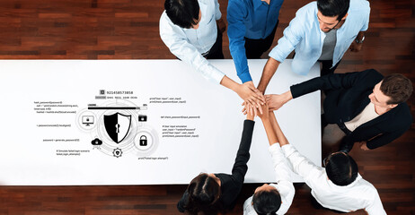 Diverse team collaborating on cyber security strategies, showcasing digital graphics and icons on a table. Focused on privacy and data protection solutions in a professional setting. Trope