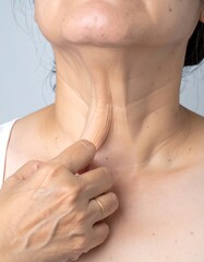 Woman's neck and hand