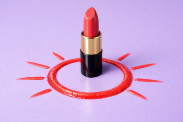 Pink Lipstick Standing In Red Sunburst Paint Circle On Purple Background