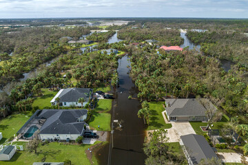 Heavy flood with high water surrounding residential houses after hurricane Ian rainfall in Florida residential area. Consequences of natural disaster