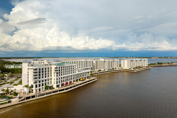 Heavy rainfall and strong winds from tropical storm above waterfront resort on Florida bay. Severe hurricane season weather.