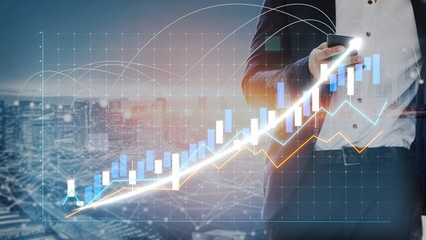 A businessman stands with a smartphone, overlayed with financial graphs and data, symbolizing growth and success against a city skyline during sunset. Copula
