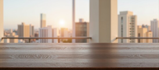 A wooden table overlooks the cityscape at sunset from a balcony with copy space.