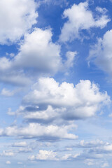 Beautiful soft gentle blue sky with white fluffy clouds background texture