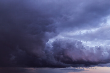Epic Dramatic Storm sky with dark grey blue violet cumulus rainy clouds abstract background texture, thunderstorm